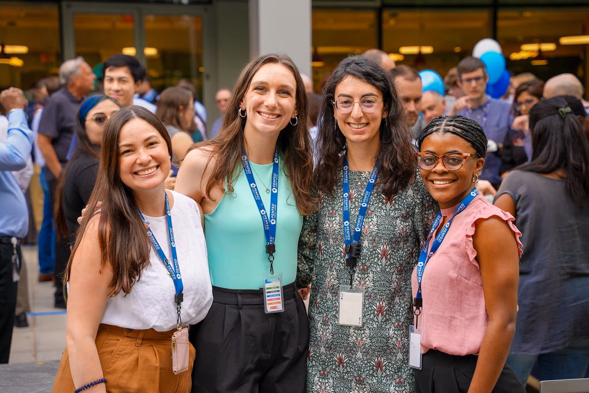 Group of PenFed workers at an event smiling.