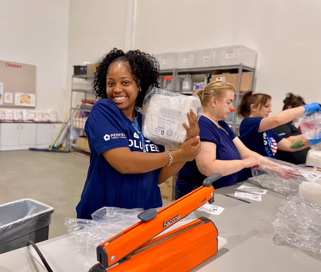 PenFed volunteers painting playground equipment