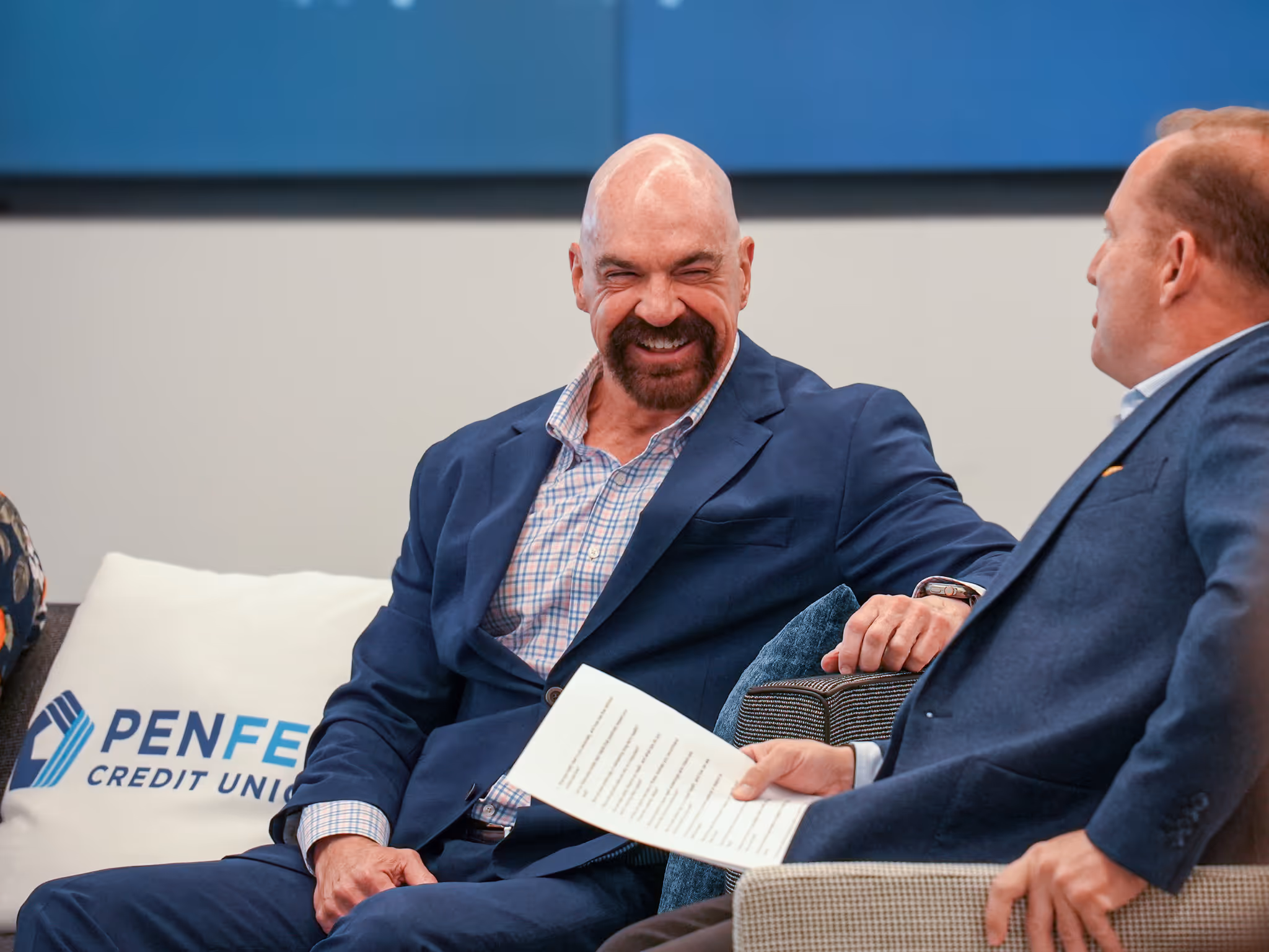 PenFed male worker laughing with a colleague