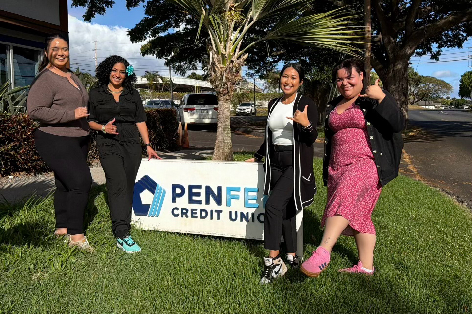 Group of PenFed workers standing with a giant teddy bear