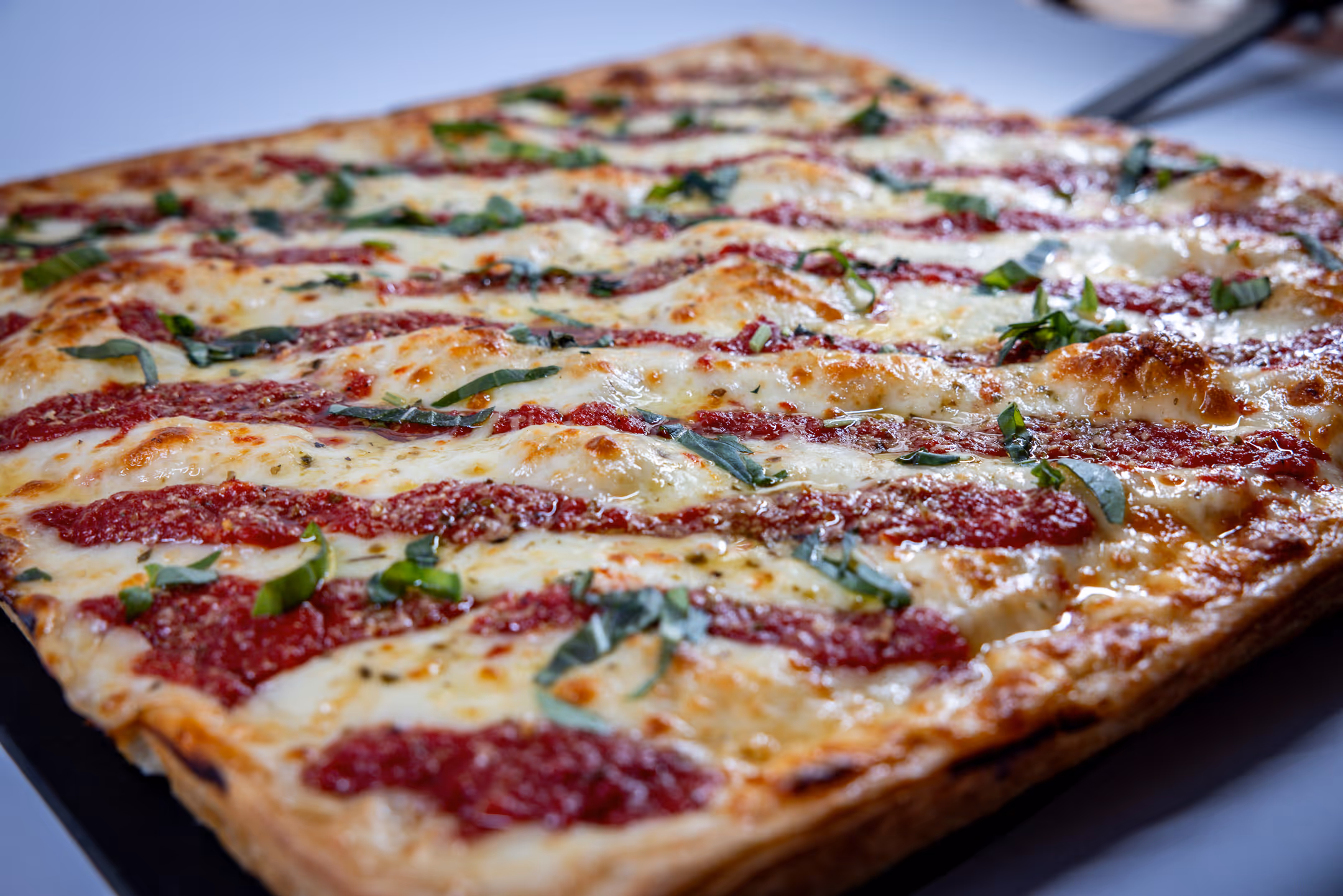 A food photography image of a pizza taken at Cafe Antonio.