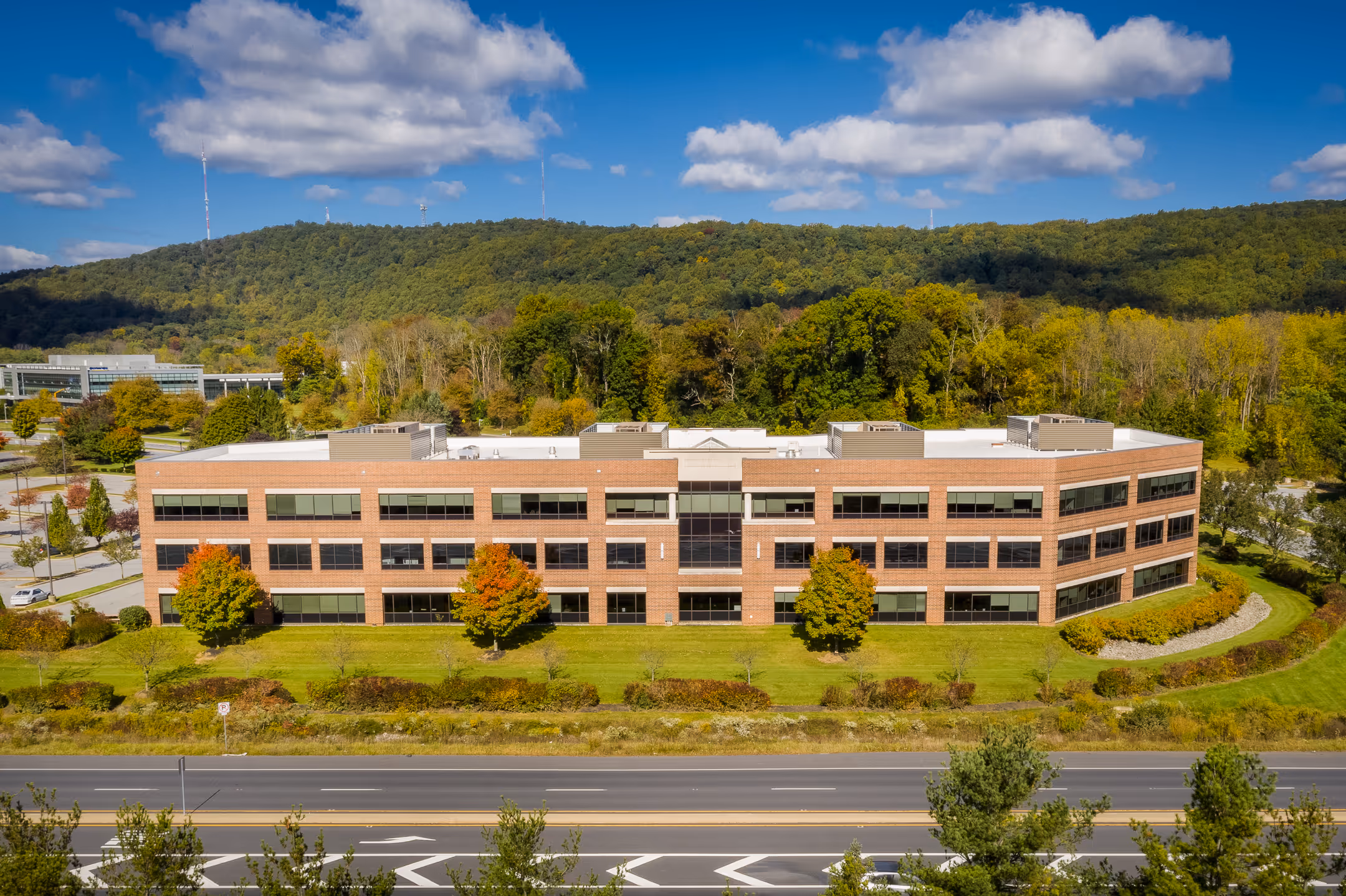 A drone photography shot of a large corporate building on a sunny day.