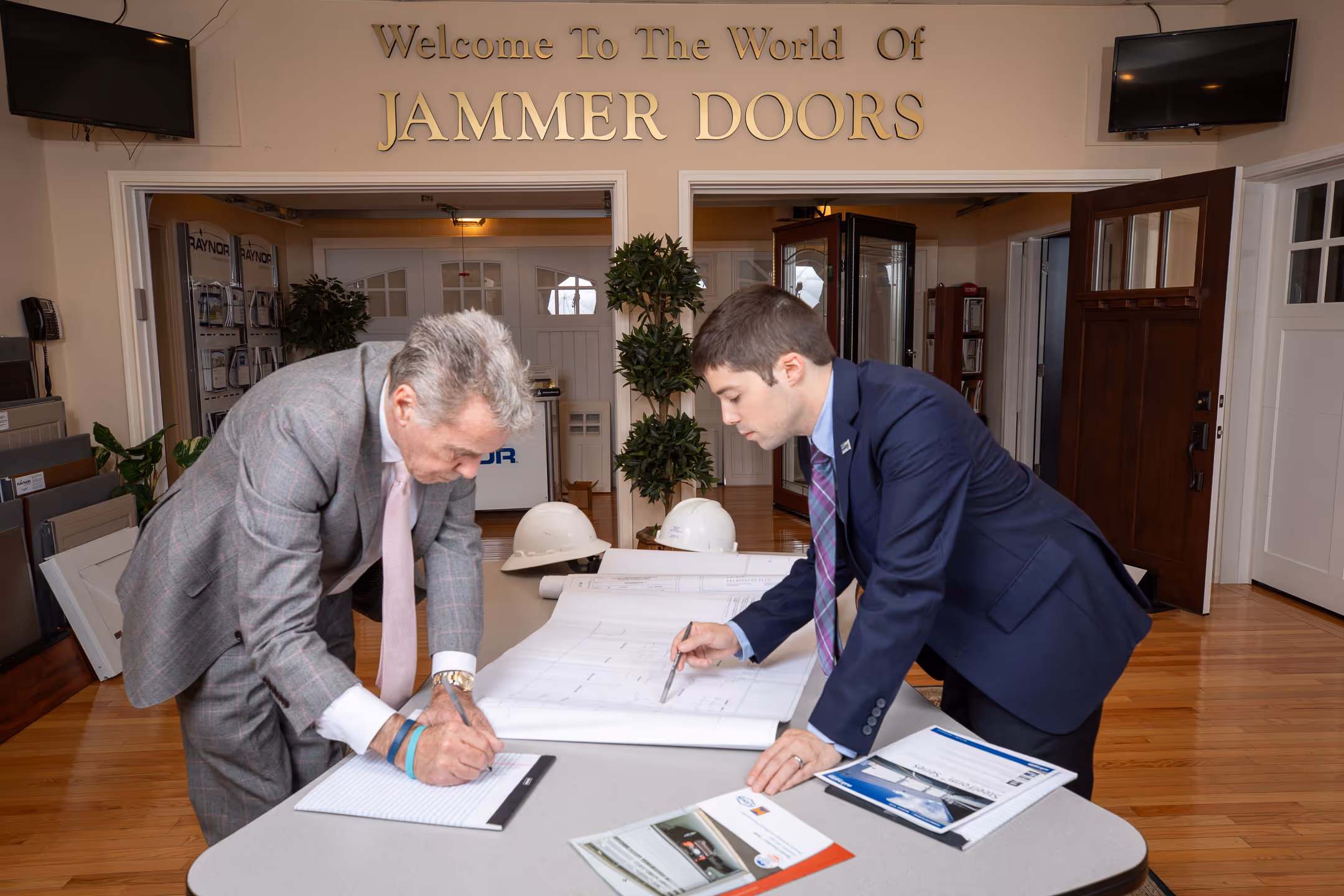 An image of two professional workers putting a project together.