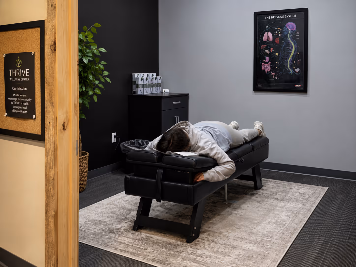 Patient lying on a chiropractic table in a treatment room at Elite Wellness Chiropractic.