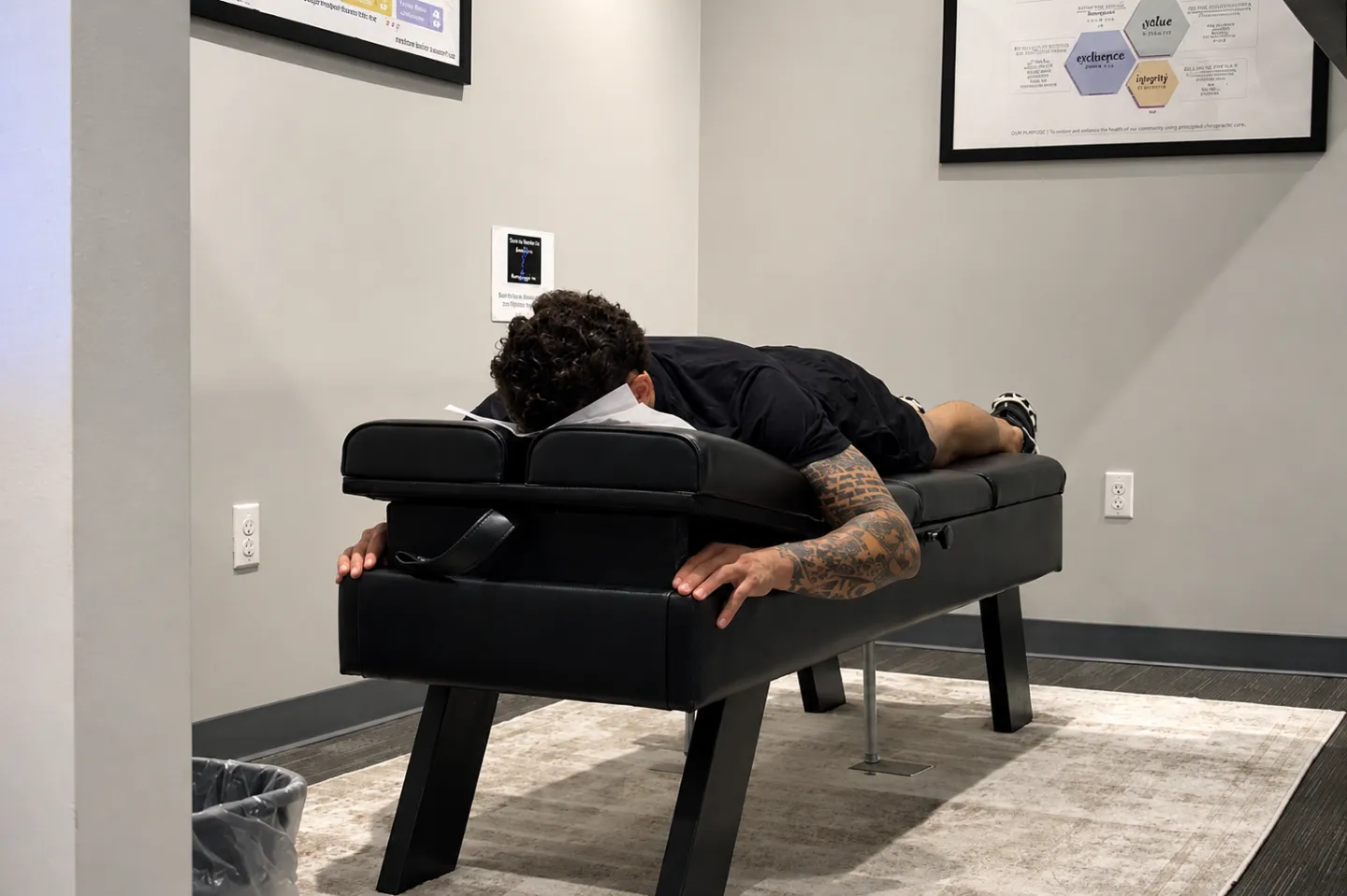 Patient lying face down on a chiropractic adjustment table at Elite Wellness Chiropractic 