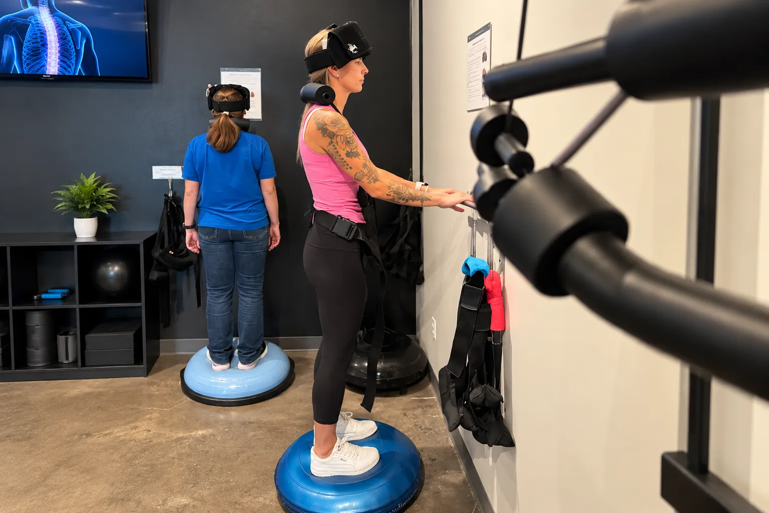 Two patients using balance equipment during corrective chiropractic care at Elite Wellness Chiropractic.