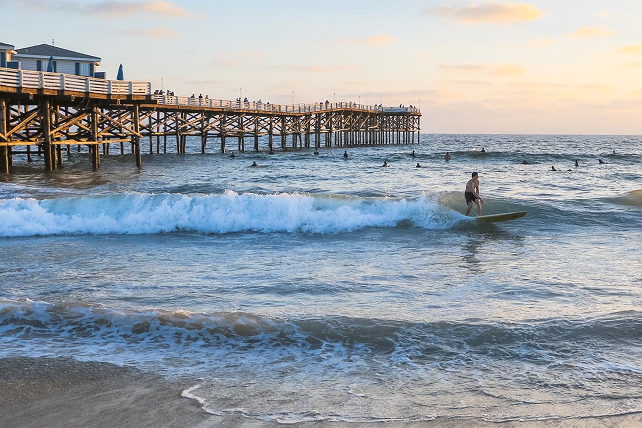 Surfer in San Diego by the pier