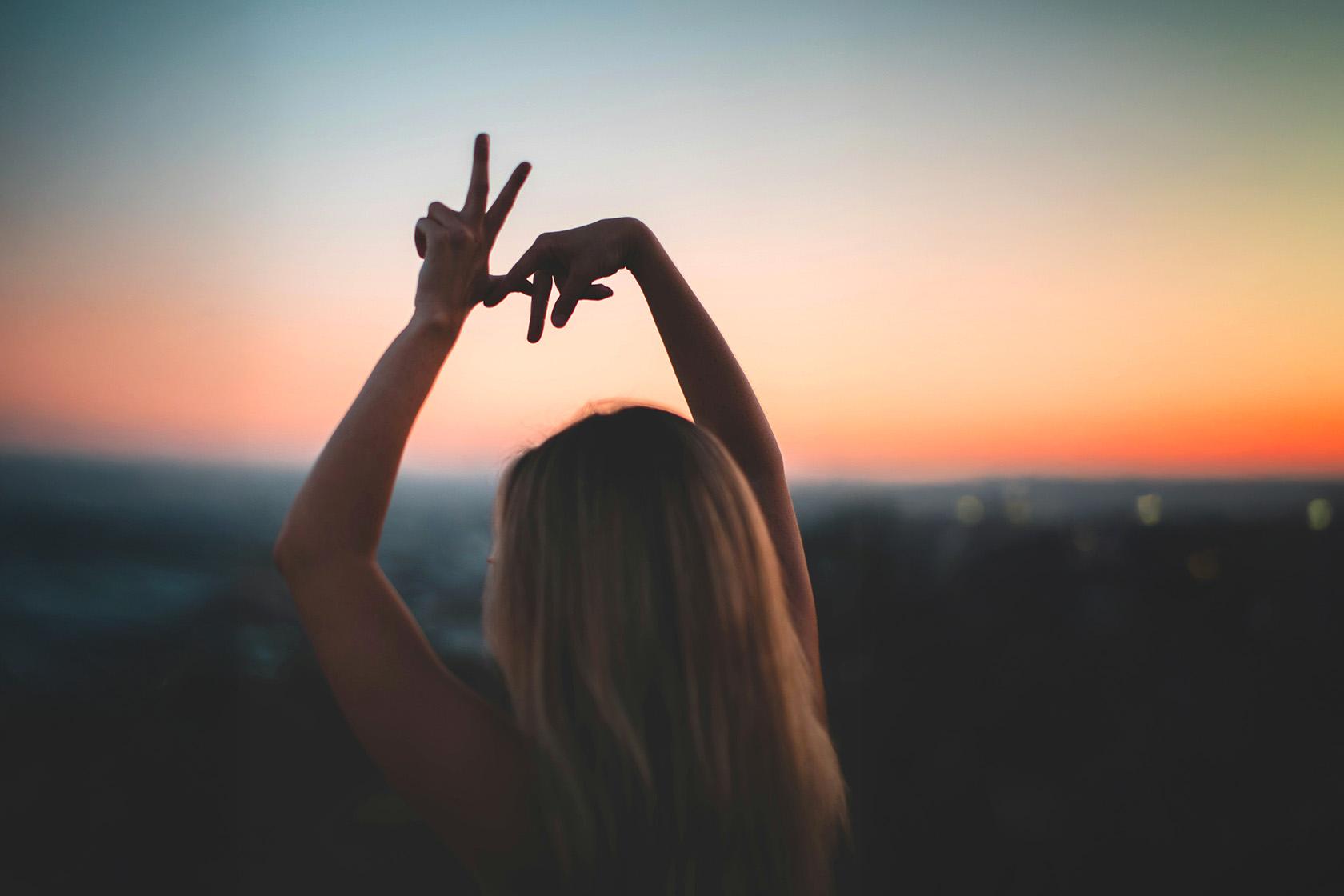 Woman throwing up LA with hands