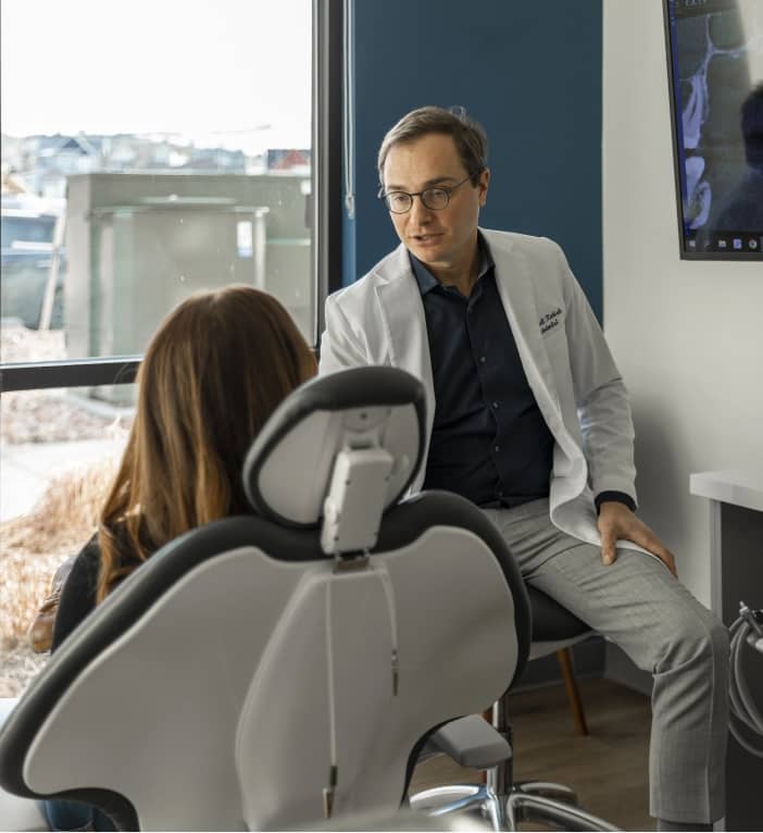 arvada avos dental specialists doctor discussing endodontic retreatment with a patient