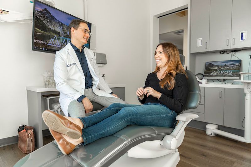 arvada avos dental specialists doctor talking to a patient about root canals