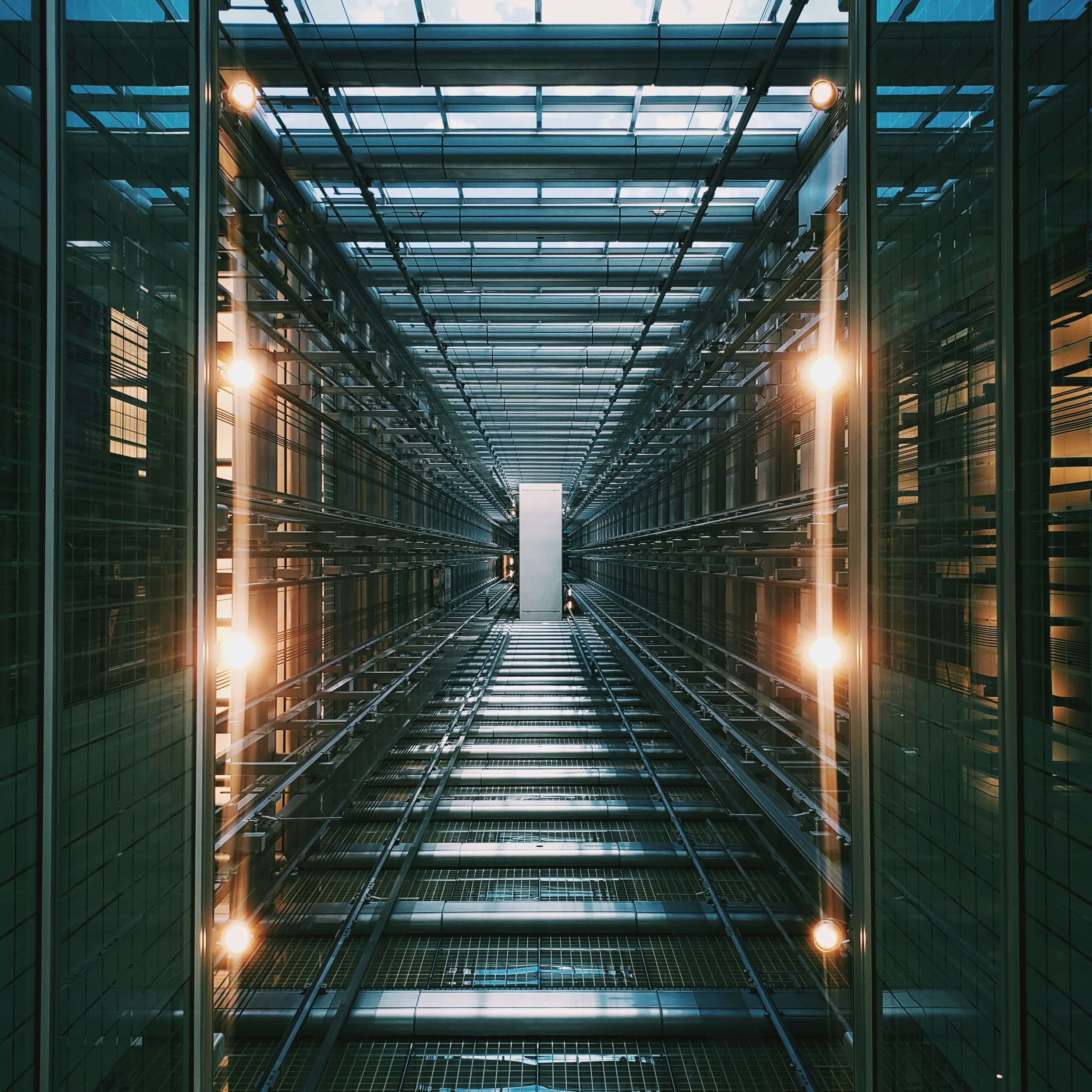 Symmetrical futuristic corridor with glass walls and glowing lights