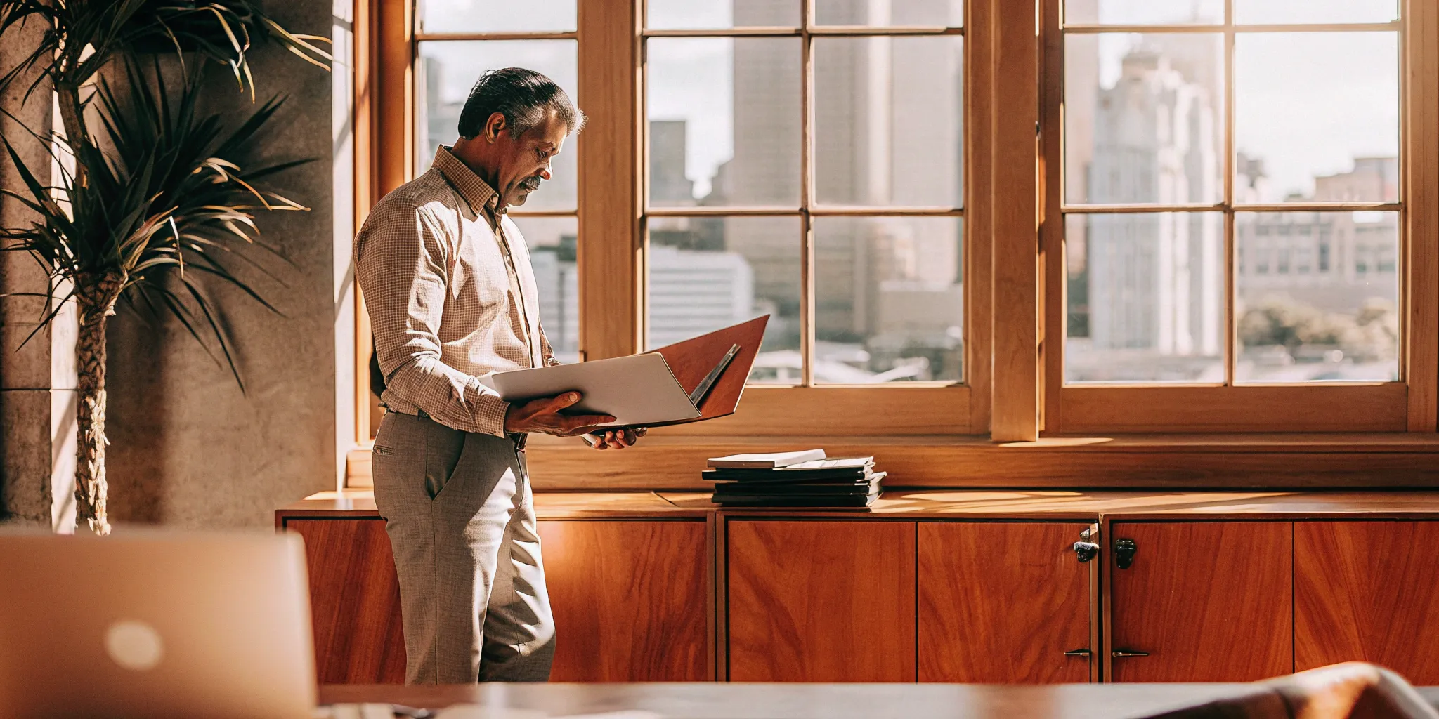 Small business owner reviewing workers' comp documents.