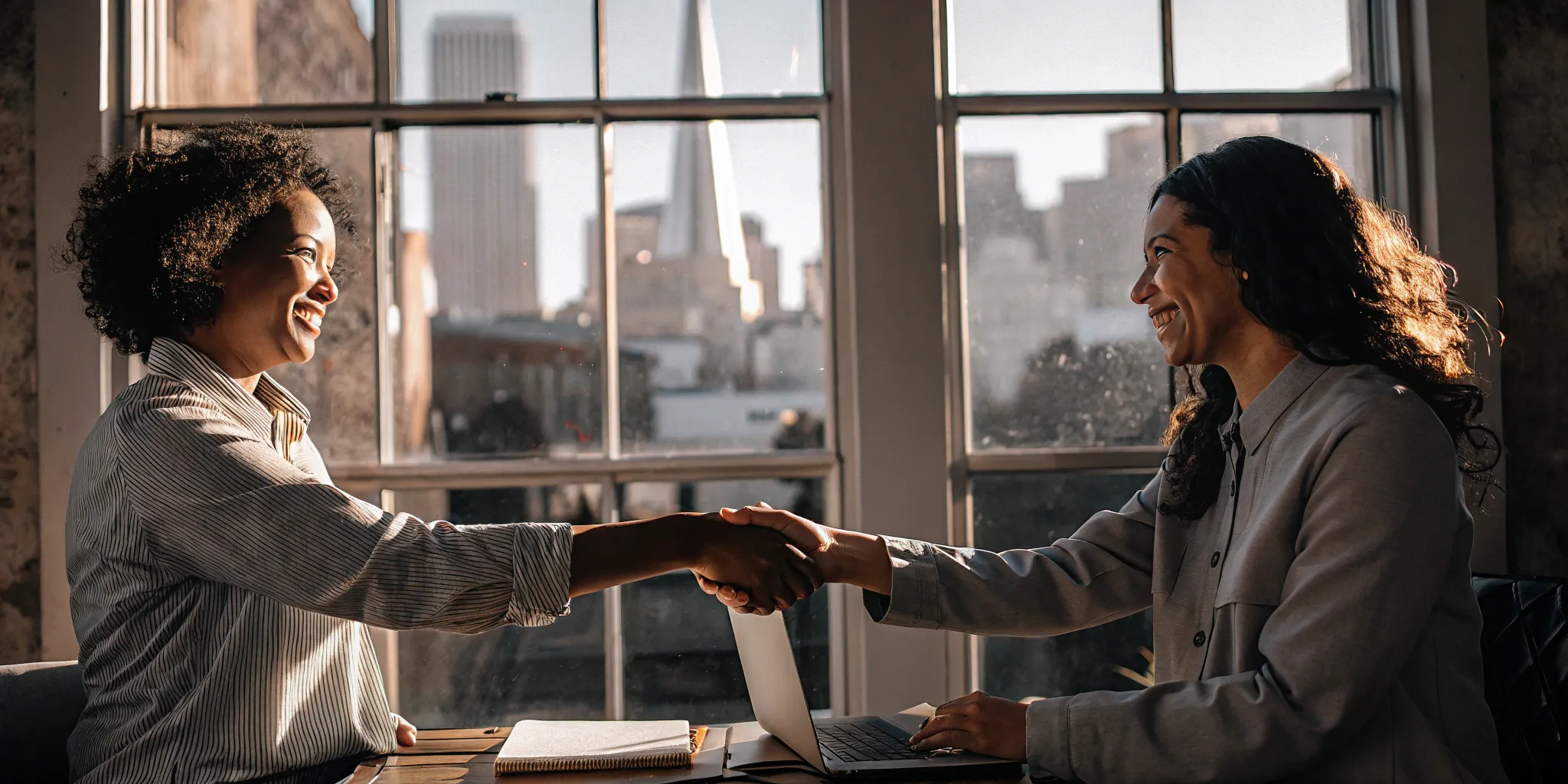 Business professionals shaking hands over the benefits of using a PEO.