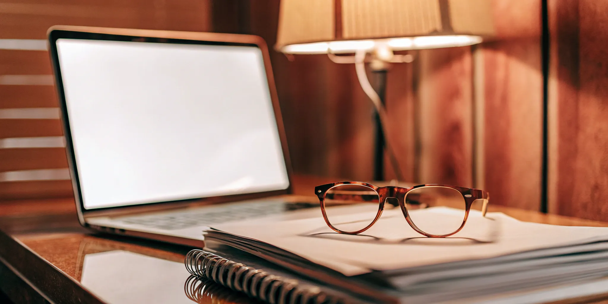 Reviewing documents for a comprehensive employee benefits package on a desk with a laptop.