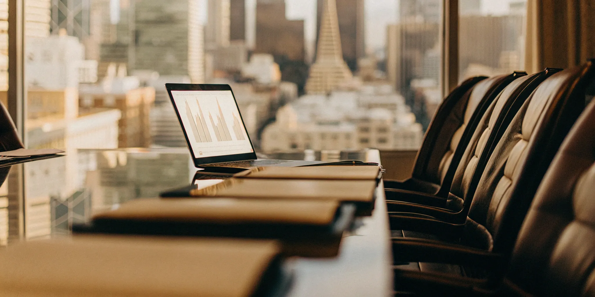 A list of employee benefits brokers is reviewed on a laptop during a business strategy meeting.