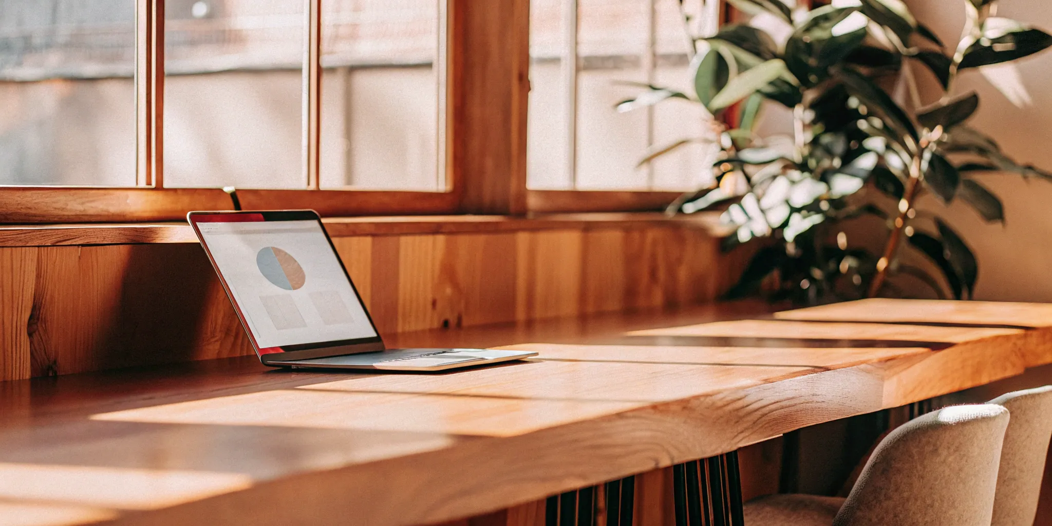 Designing a strategic employee benefits plan on a laptop in a modern office.