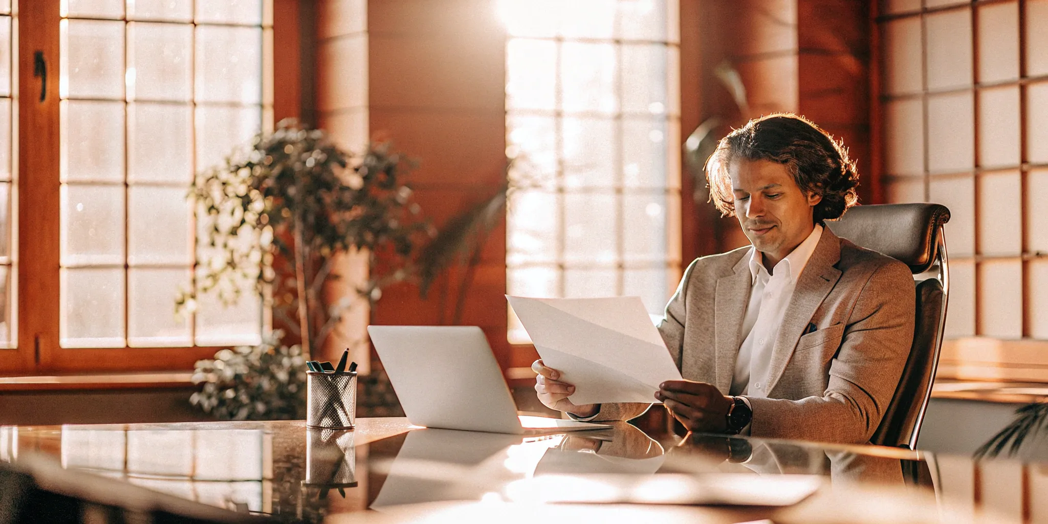 A professional at a desk preparing for a PEO admin fee negotiation.