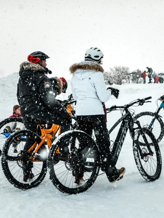 Mountain biking on snow in winter in Combloux, adventure in the French Alps near Mont-Blanc.