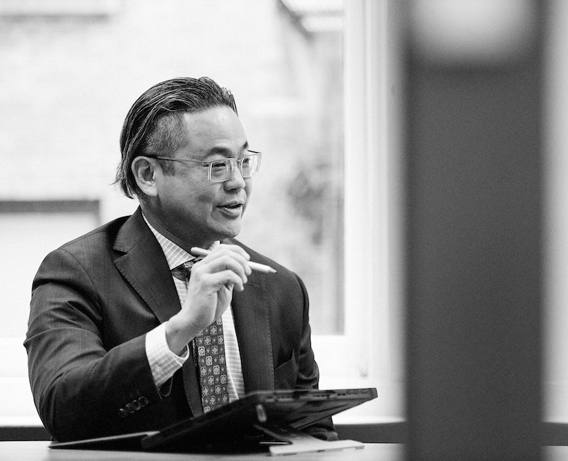 Picture of Chilwin speaking and holding an ipad