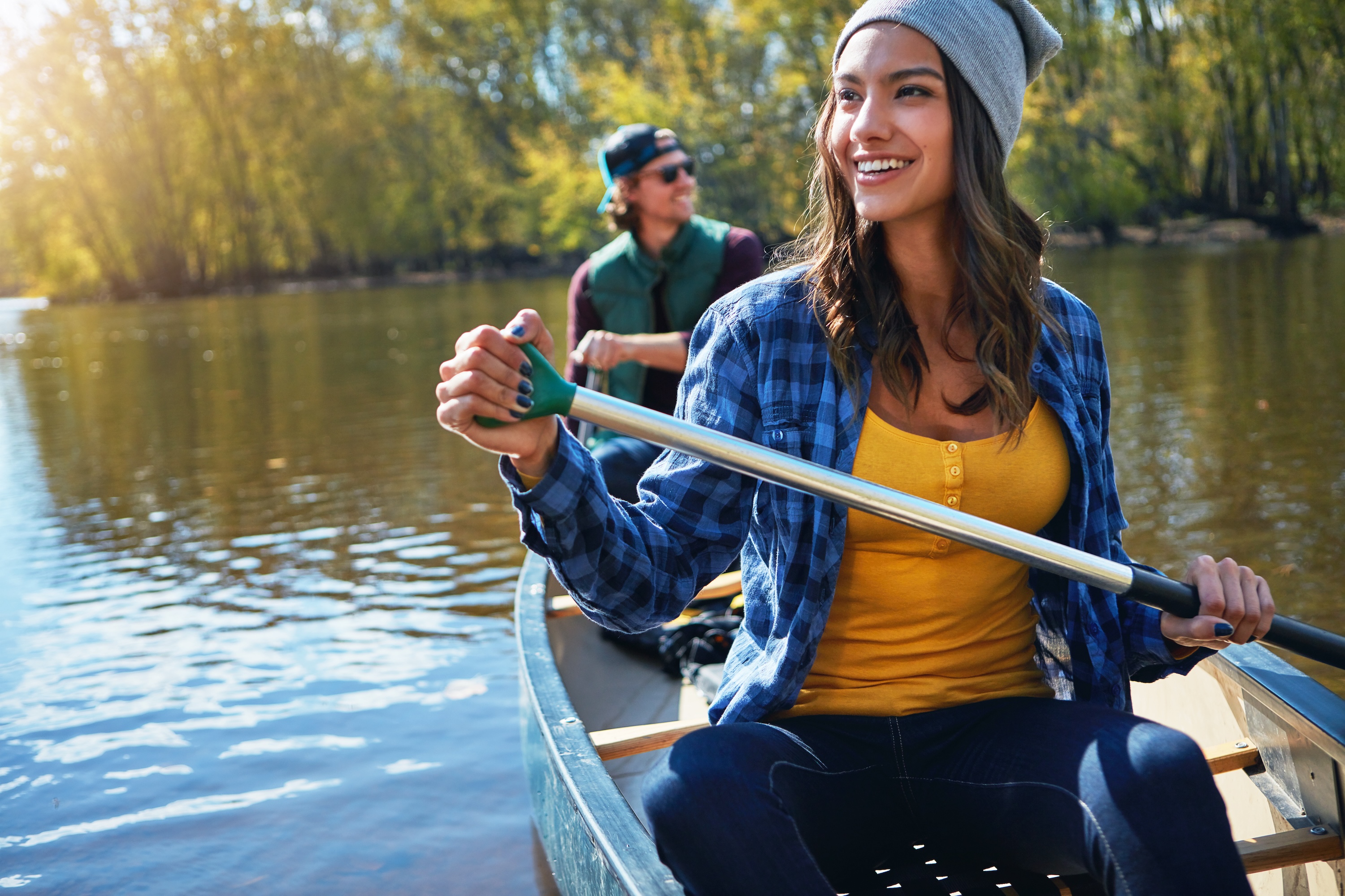 Residents enjoying a scenic outdoor canoe trip on a river near The Rook apartments in Orlando, FL.