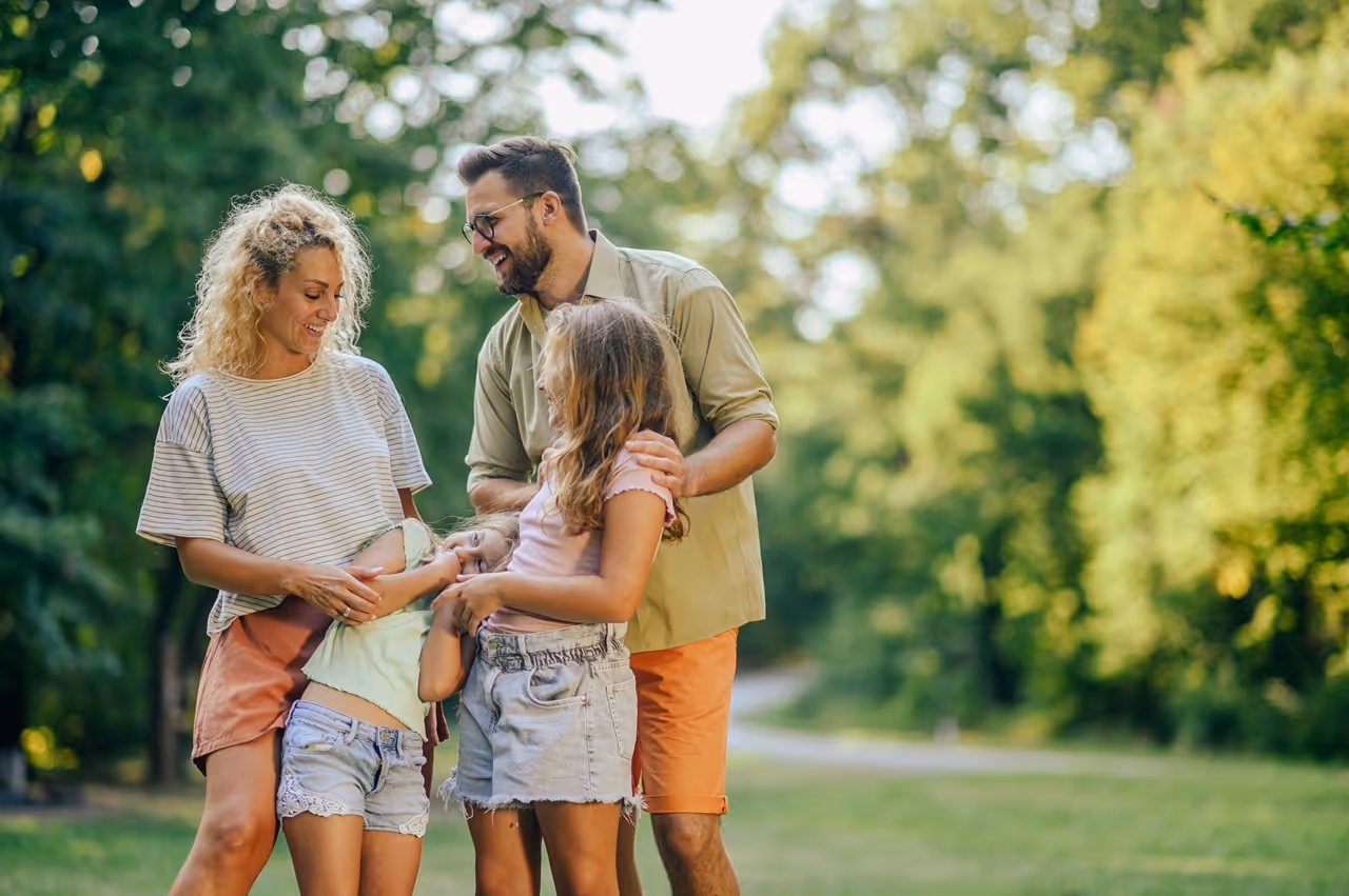 Parents discussing co-parenting plan with mediator for better communication and holiday schedules