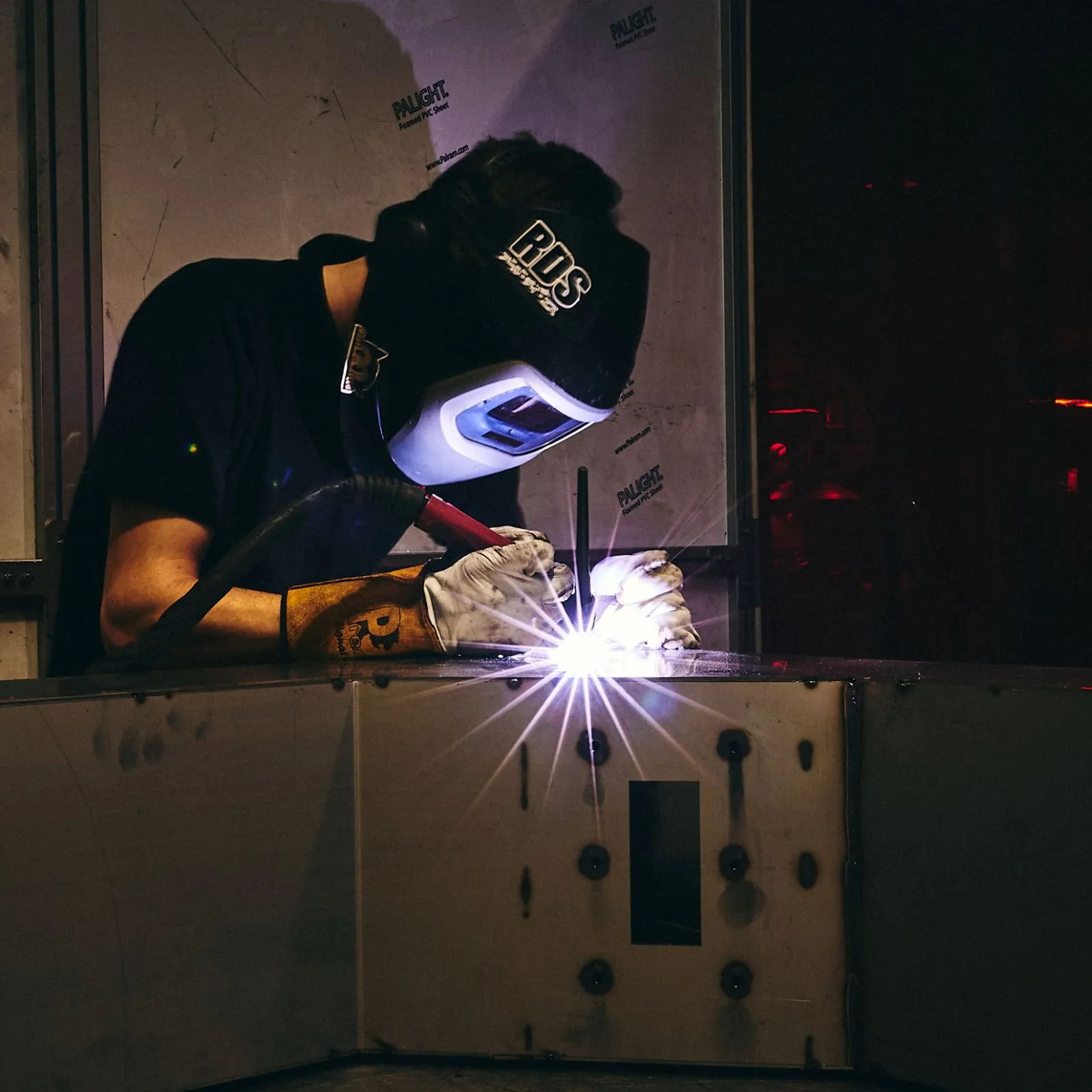 A welder working on a piece of metal.