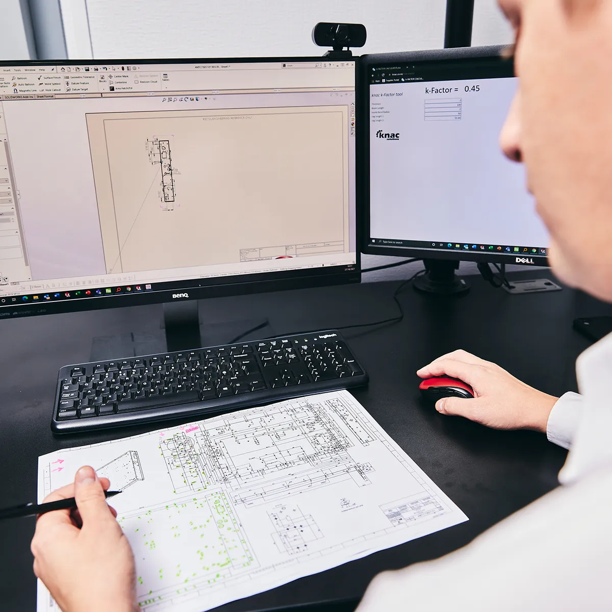 A man sitting at a desk working on a computer.