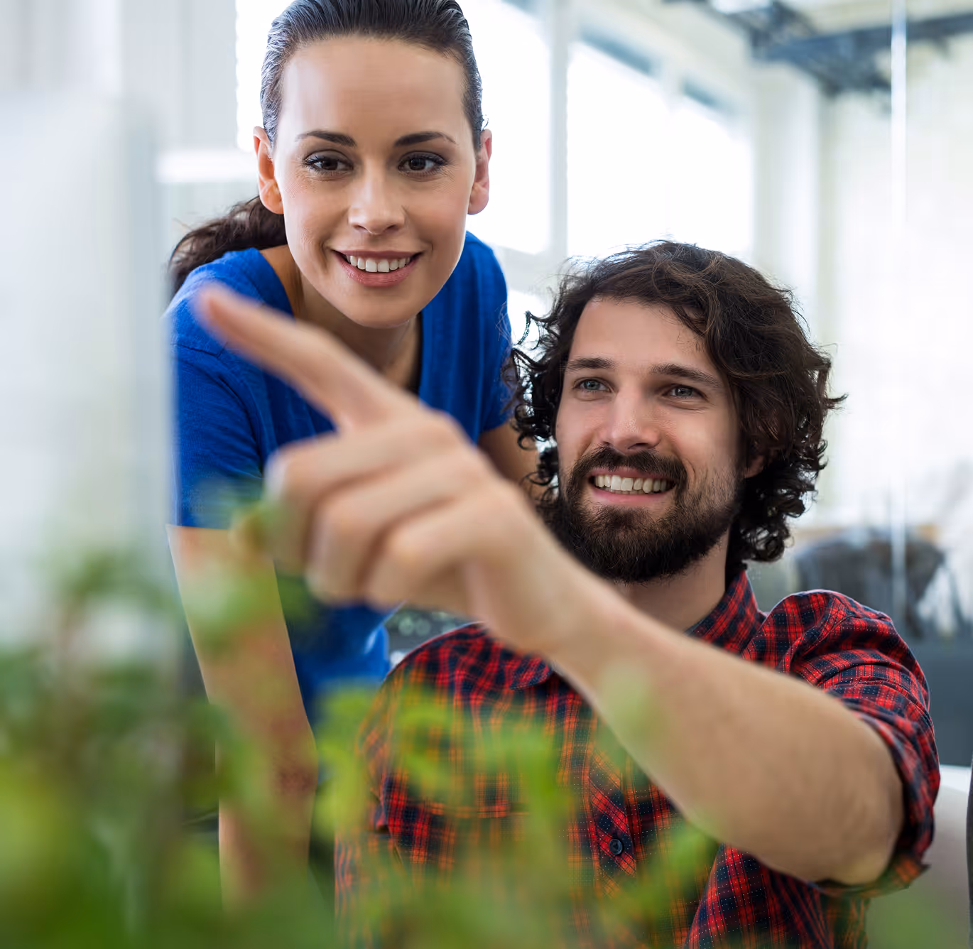 Two warehouse workers in safety gear reviewing a digital inspection checklist showing 100% score and 'Inspection passed' status.