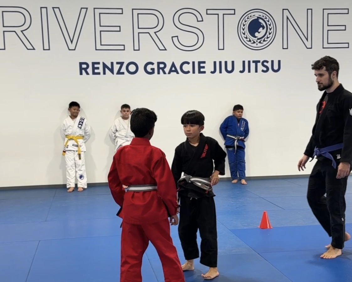 Students in BJJ gi preparing to spar