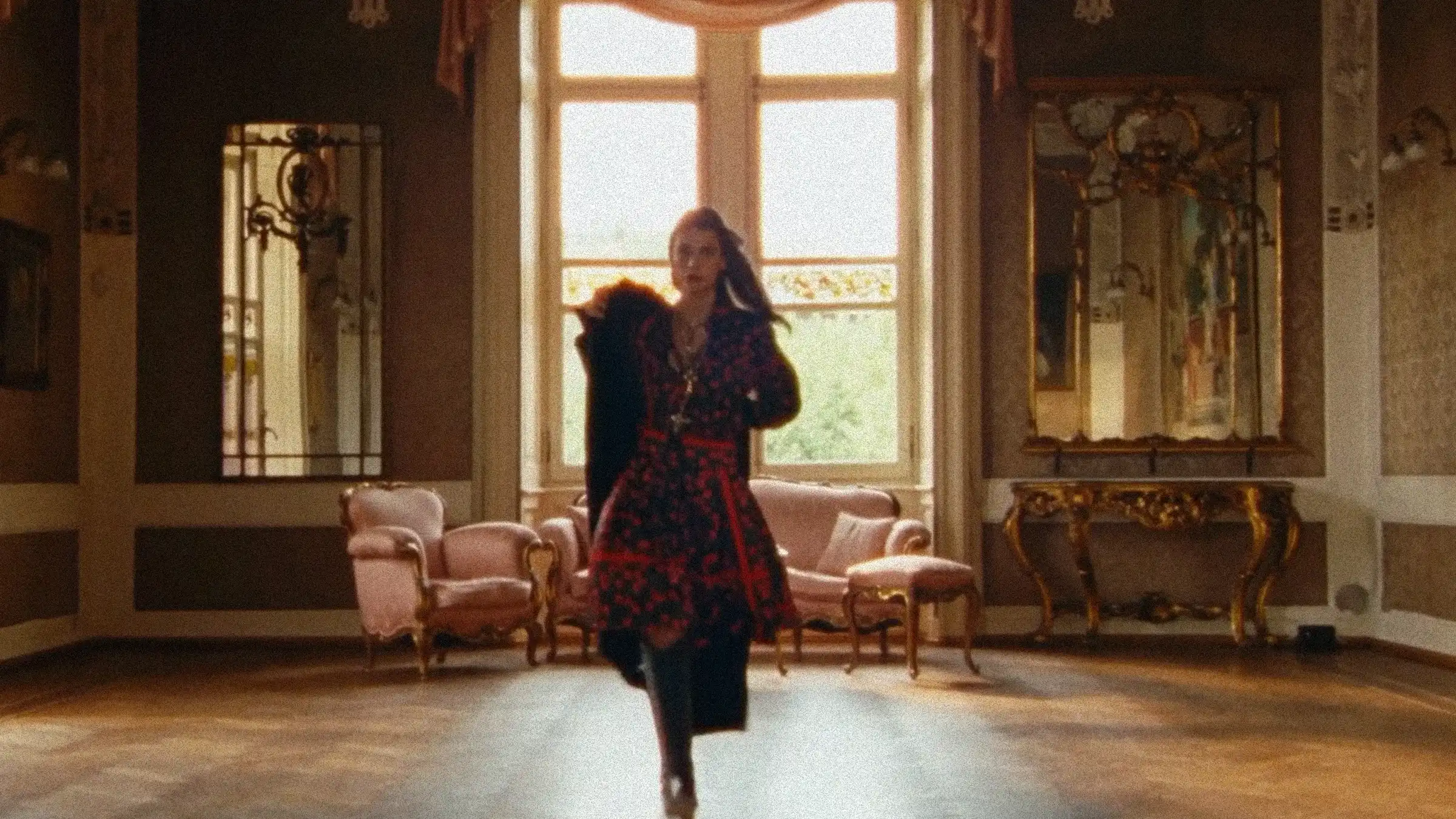 A model walking through an ornate Milanese salon in a red printed coat — MAXIMILIAN F/W campaign film by Studio ONOM.