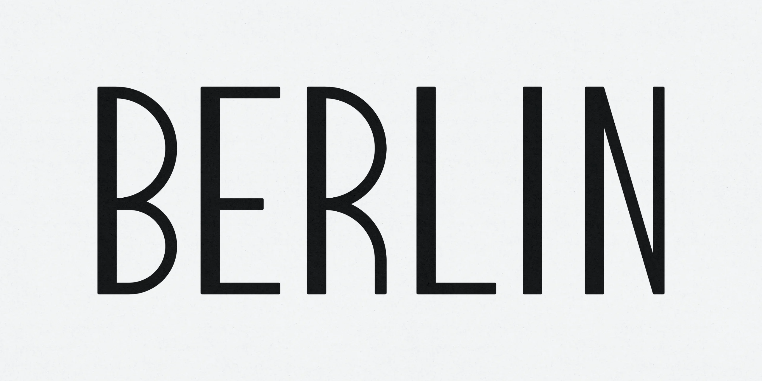 Letterforms of Berlin Condensed showing the open bowls of the B and R — type design by Studio ONOM.