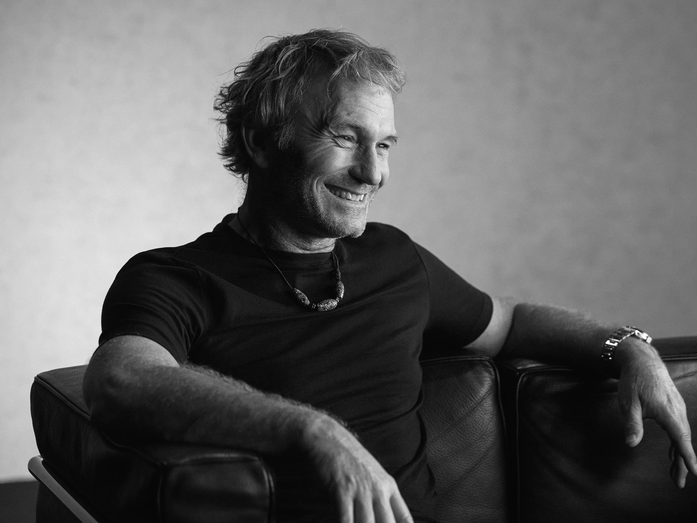 Florian Engert laughing in a leather armchair wearing the LÖBNER chronograph, directed and produced by Studio ONOM