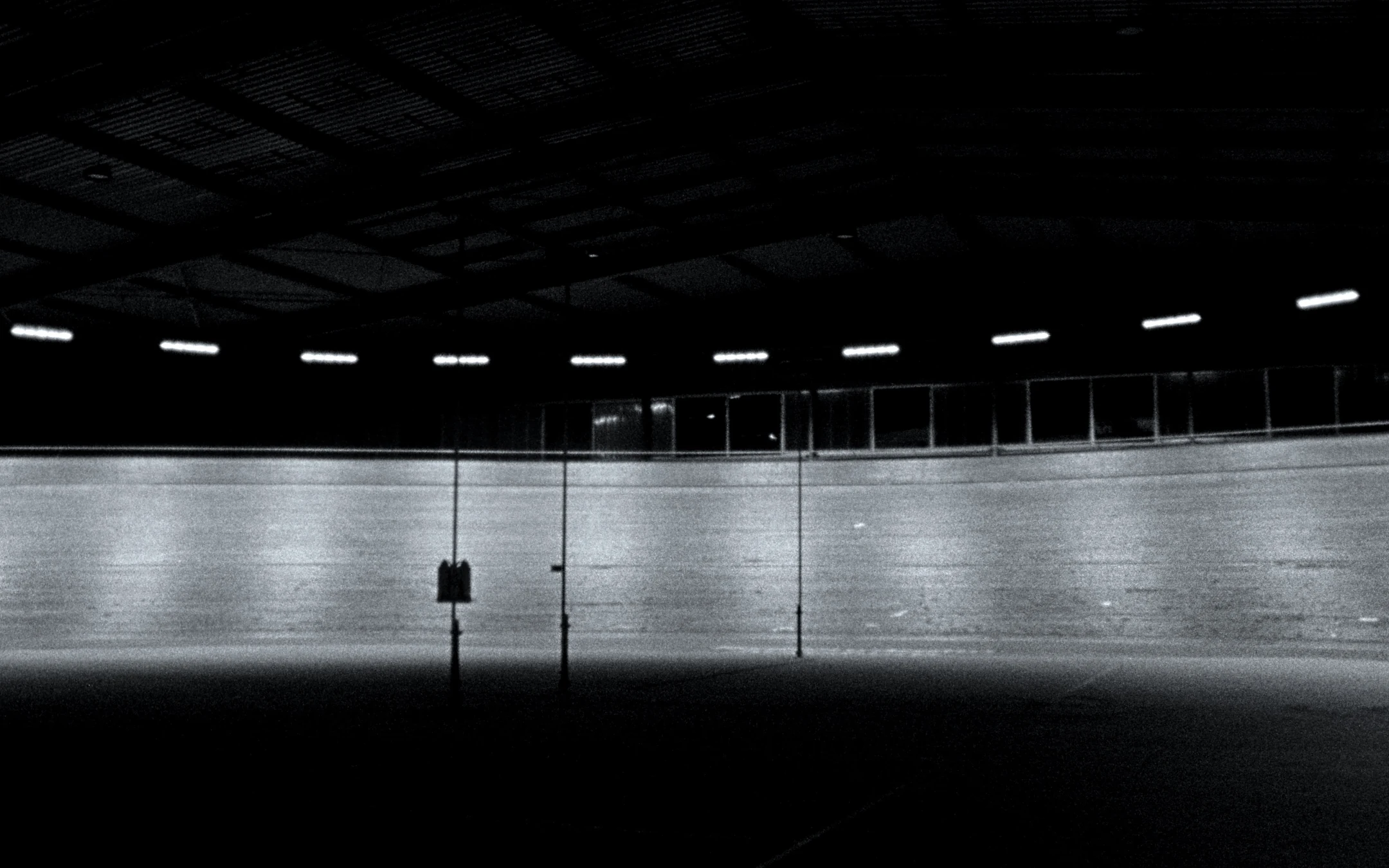 Empty velodrome at night, banked track under ceiling lights — LAPS by Dominik Leingartner, produced by Studio ONOM