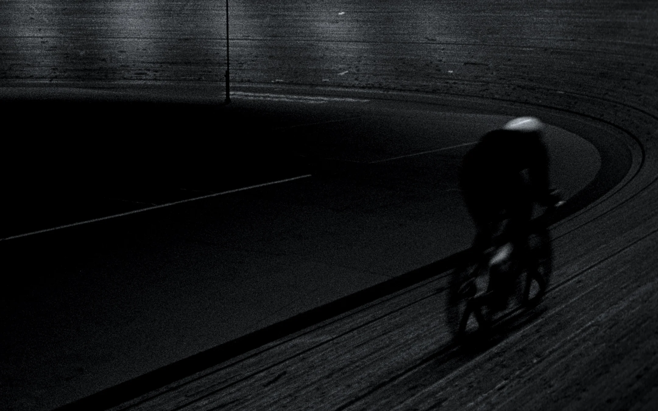 Track cyclist on the steep banking in near-darkness, LAPS by Dominik Leingartner, produced by Studio ONOM