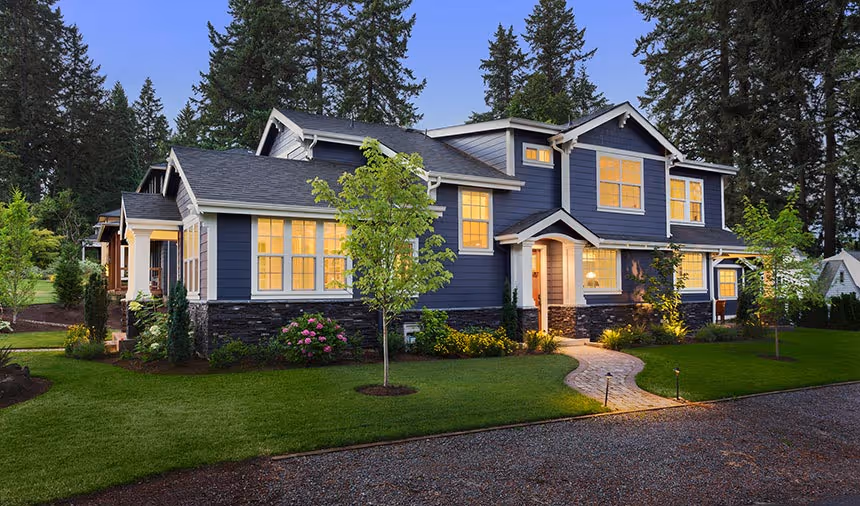 A large blue house with glowing windows.