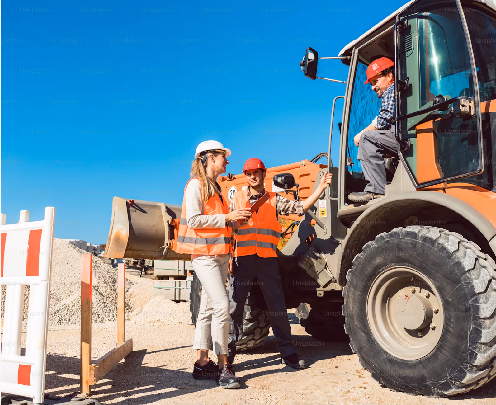 Three construction workers in safety gear using Rux Asset Management Software and Field Service Software beside a large orange excavator on a sunny day.