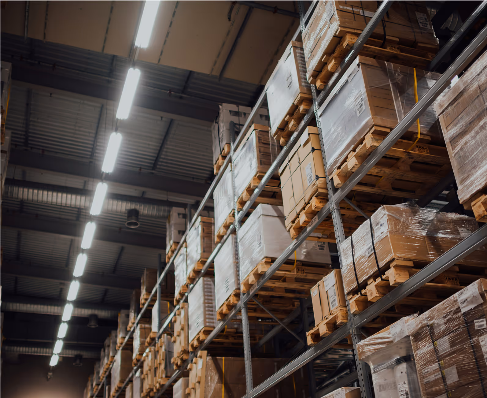 Large warehouse with tall shelves of boxed goods, managed using RUX business apps and field service tools