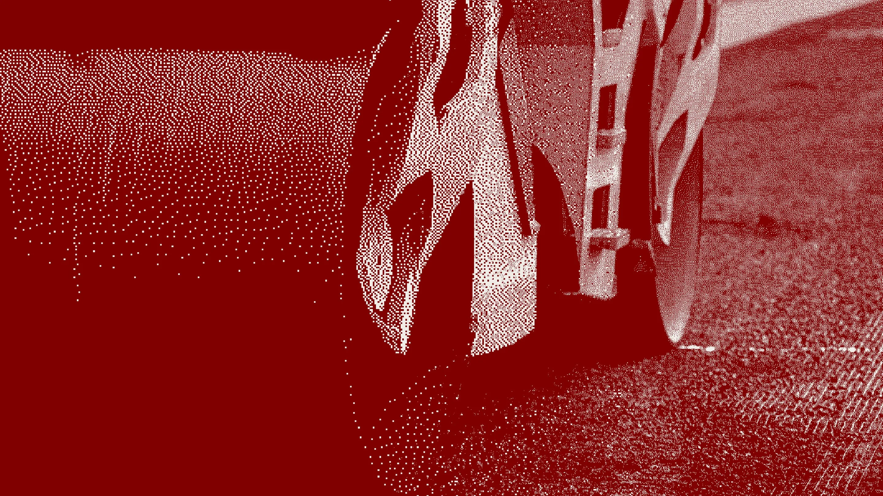 Close-up of a vehicle's wheel on a road surface with a red filter, representing RUX Asset Management Solution and Field Service Management Solution