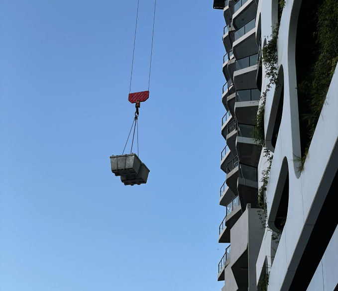 Crane holding construction items at a job site