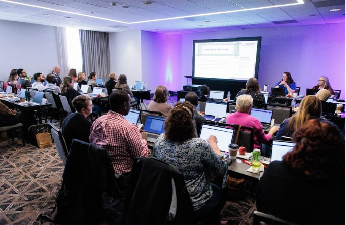 A group of people in a room with computersAI-generated content may be incorrect.