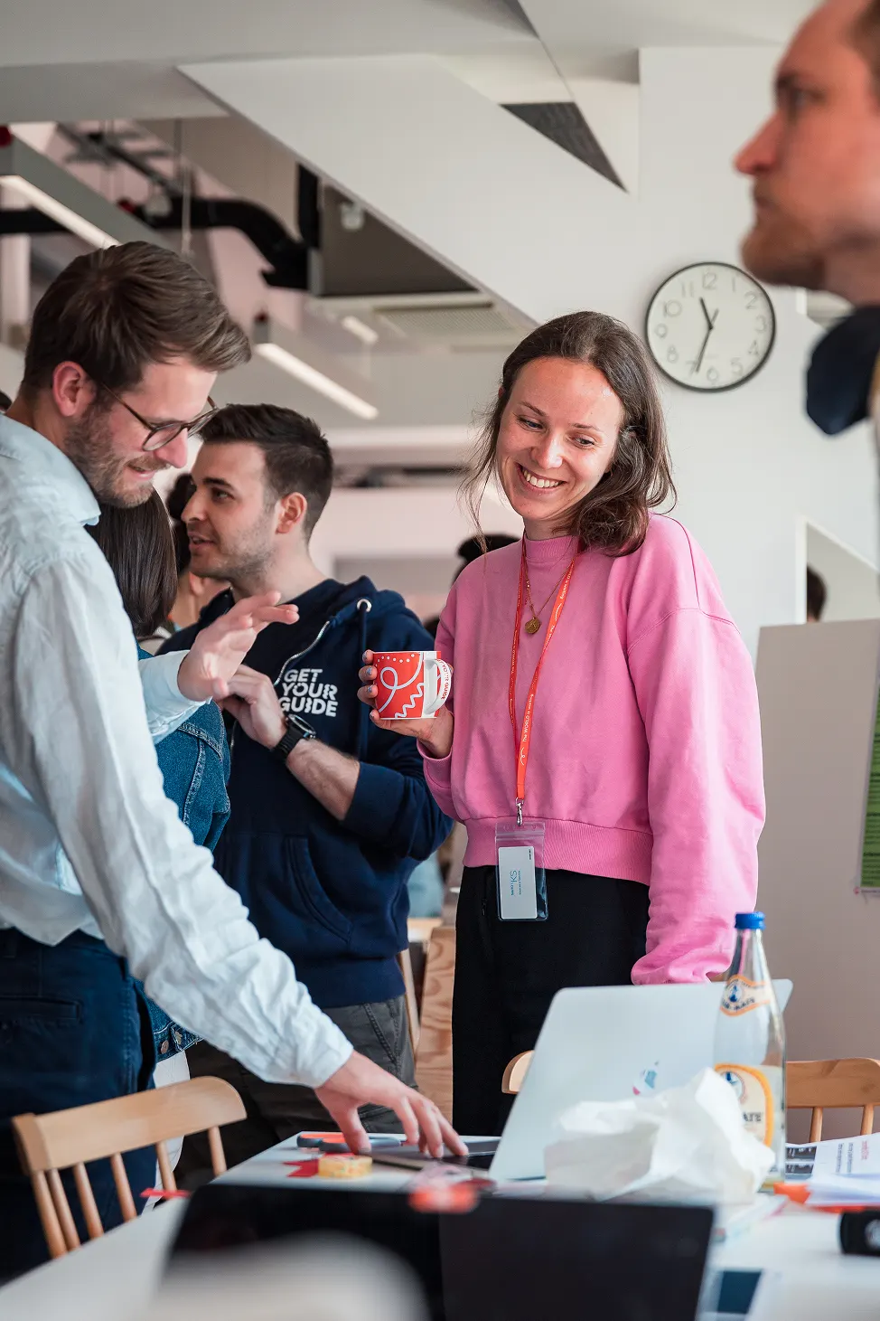 A group of people working together with a big smile on woman's face.
