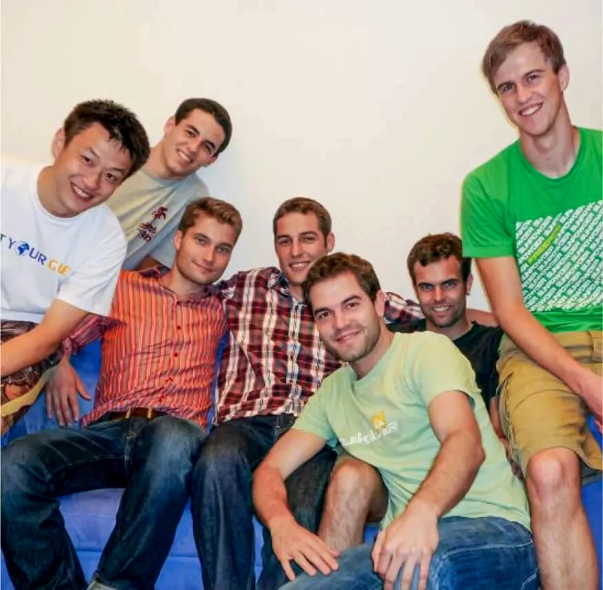 A group photo of multiple persons all smiling towards the camera.