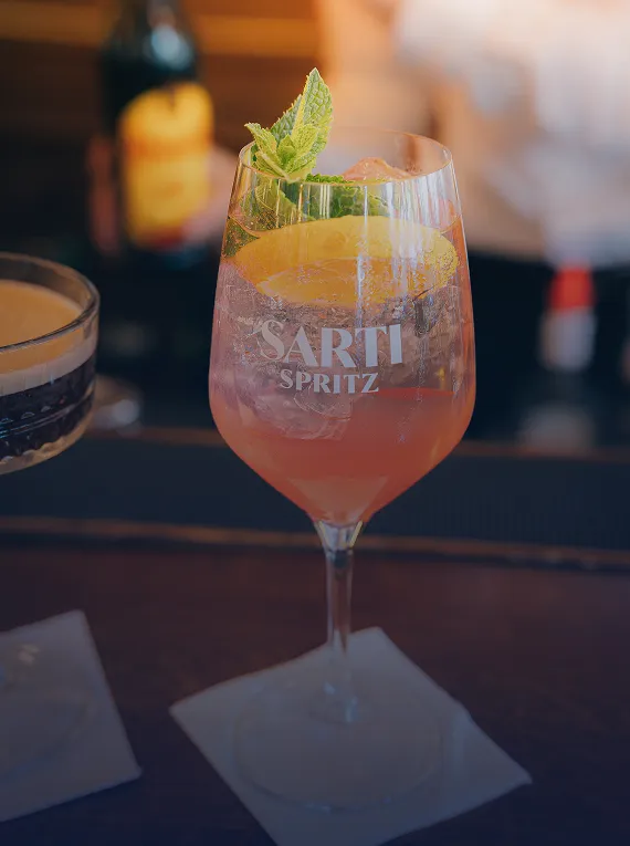 Cocktail rosé servi au bar avec décoration fraîche