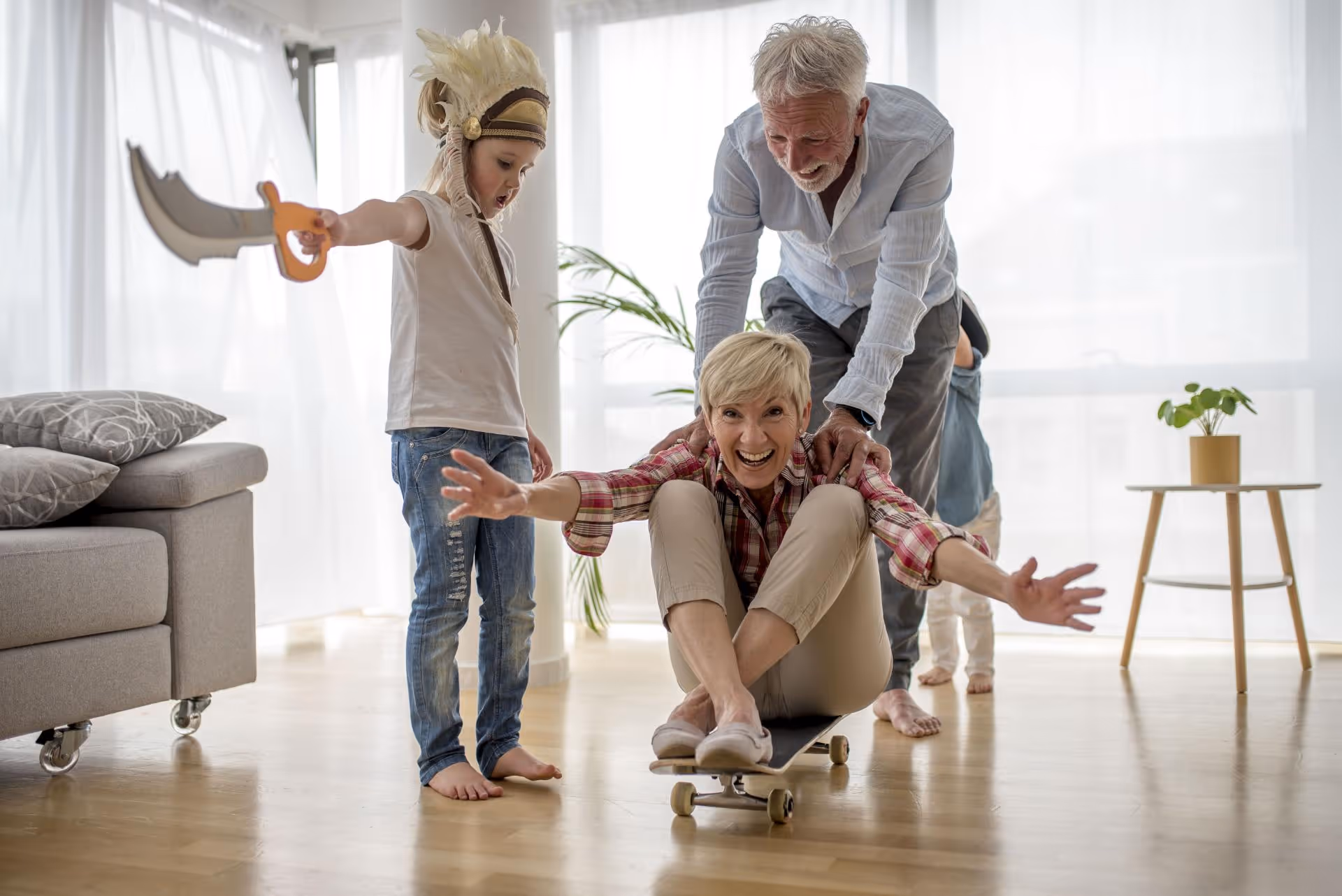A woman riding a skateboard next to two children.