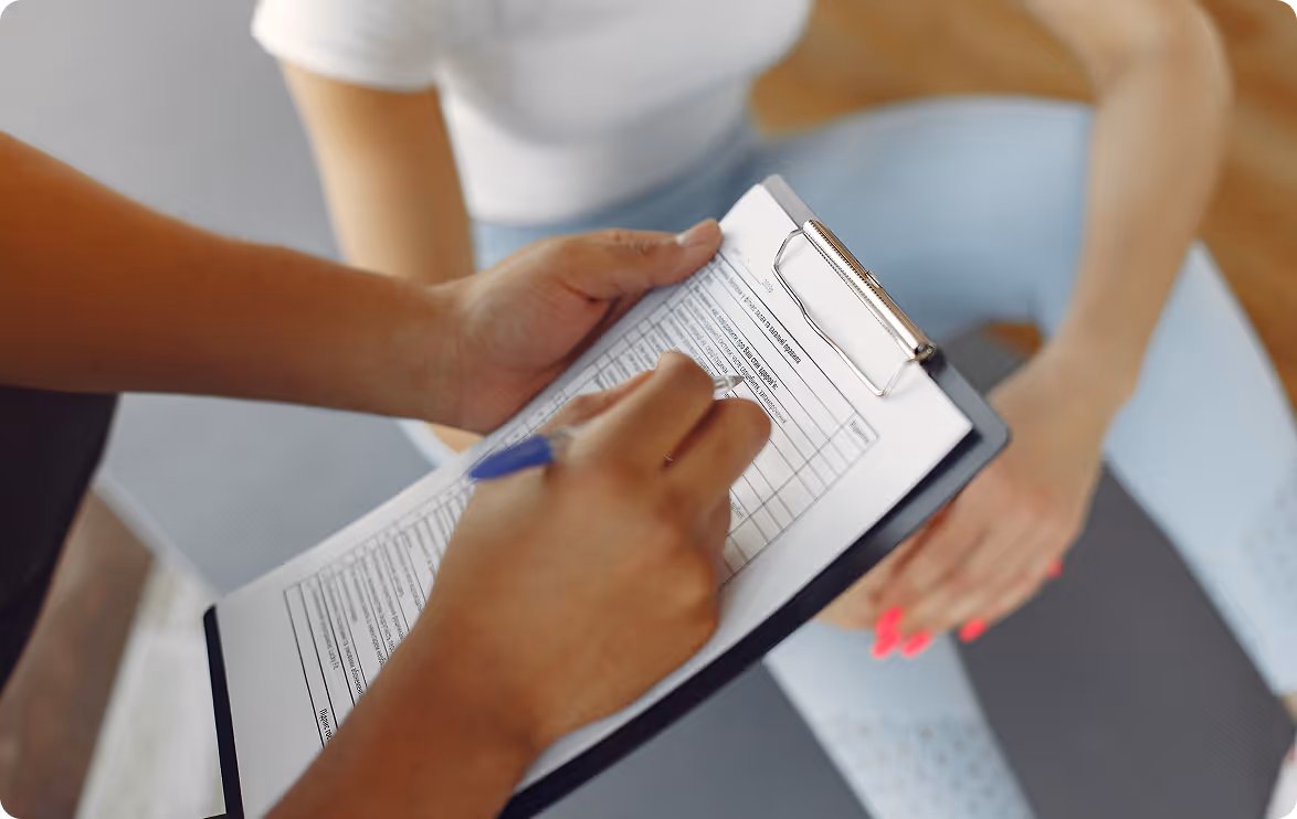 A person is writing on a piece of paper.