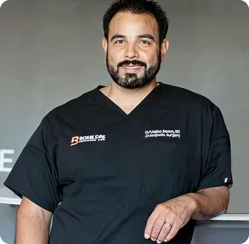 A man with a beard and a black shirt.