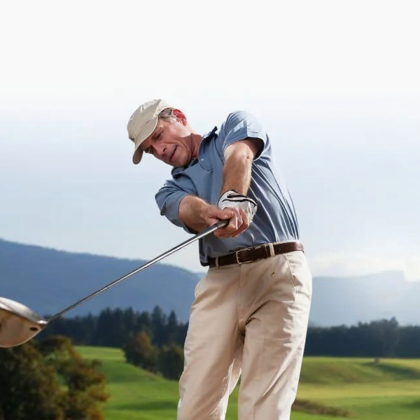 A man hitting a golf ball with a golf club.