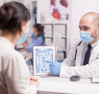 A doctor is looking at a x - ray image on a tablet.