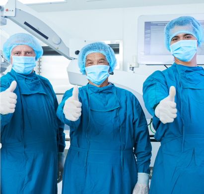 A group of doctors in scrubs giving thumbs up.