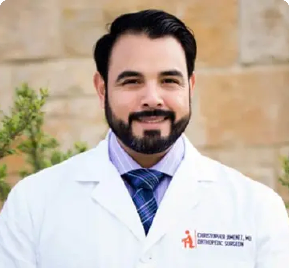 A man with a beard wearing a lab coat.